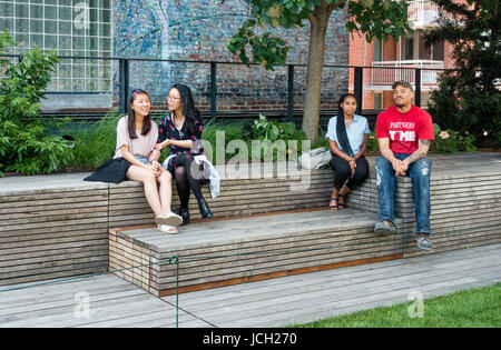 Young people relaxing on the High Line in Chelsea, New York City Stock Photo