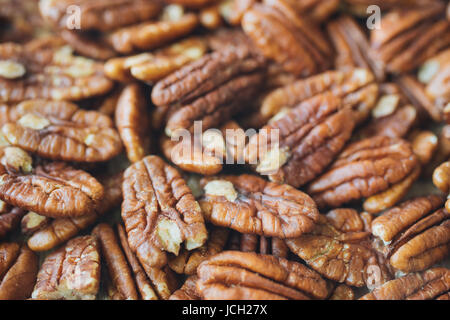 Closeup on shelled pecans. Background of organic pecan nuts, selective focus Stock Photo