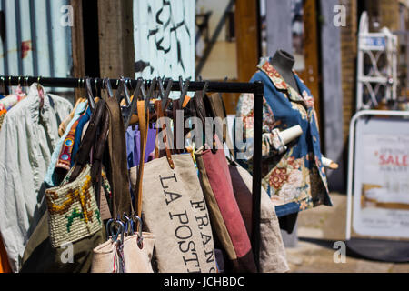 Vintage and secondhand clothes and objects jostle for space athe Columbia Road Flower Market, London Stock Photo