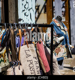 Vintage and secondhand clothes and objects jostle for space athe Columbia Road Flower Market, London Stock Photo