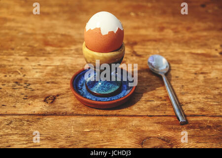A boiled egg in a beautiful painted egg cup Stock Photo