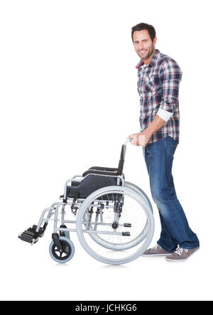 Portrait of young man with wheelchair. Isolated on white Stock Photo