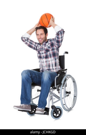 Man in wheelchair with basketball. Isolated on white Stock Photo