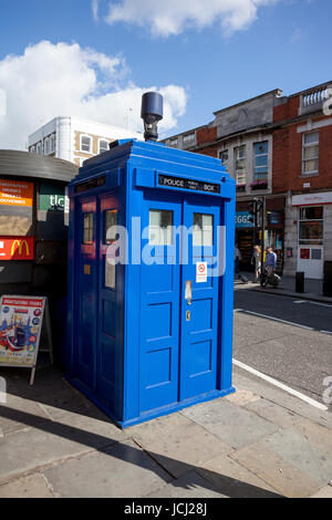 LONDON - JUNE 11, 2014: Public call police box with mounted a modern surveillance camera near Earl's Court tube station in London. Stock Photo