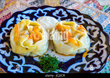 Traditional freshly cooked manty (dumplings) served on the plate Stock Photo