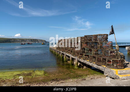 Crab and lobster pots on the quayside on Swanage Bay Dorset England UK Stock Photo