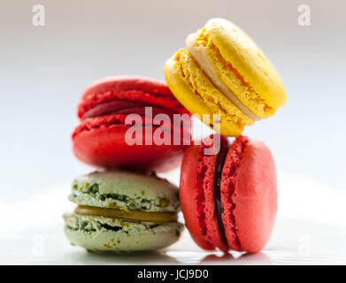Colourful macarons on a vintage white plate Stock Photo