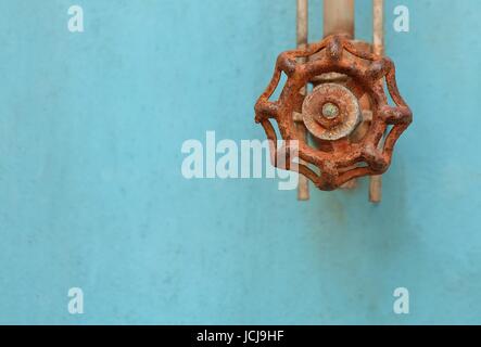 Rusted Valve and Pipe with Old Glass Tube on The Blue Metal Grunge Boiler Machine. Stock Photo