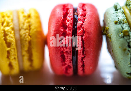 Colourful macarons on a vintage white plate Stock Photo