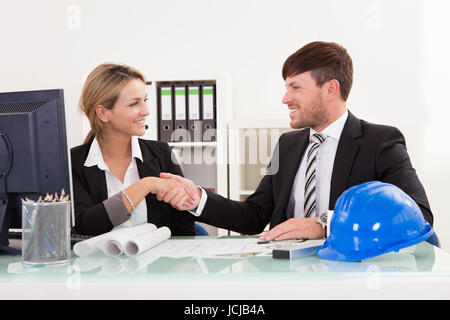 Architects shaking hands in the office after reaching agreement Stock Photo
