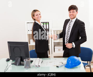 Architects shaking hands in the office after reaching agreement Stock Photo