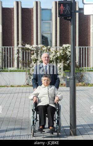 old couple walks on the pedestrian crossing Stock Photo