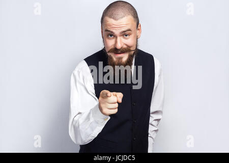 Hey You. Handsome businessman with beard and handlebar mustache looking at camera. studio shot, on gray background. Stock Photo
