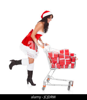 Woman In Santa Claus Pushing Cart With Present Over White Background Stock Photo