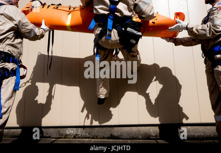 Crews practice high angle rescue at a public training facility at an industrial site in Oregon using ropes, litters and rappelling techniques. Stock Photo