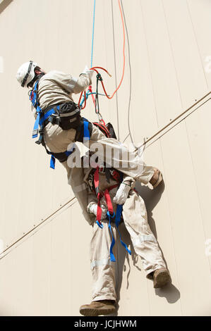 Crews practice high angle rescue at a public training facility at an industrial site in Oregon using ropes, litters and rappelling techniques. Stock Photo