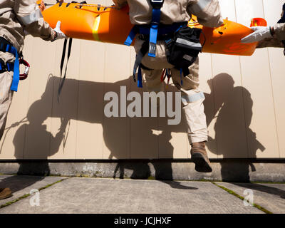 Crews practice high angle rescue at a public training facility at an industrial site in Oregon using ropes, litters and rappelling techniques. Stock Photo