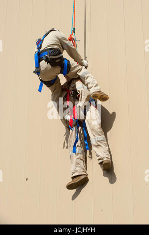 Crews practice high angle rescue at a public training facility at an industrial site in Oregon using ropes, litters and rappelling techniques. Stock Photo