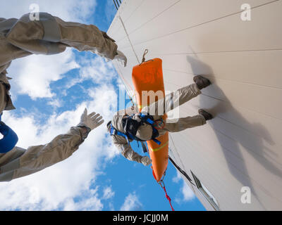 Crews practice high angle rescue at a public training facility at an industrial site in Oregon using ropes, litters and rappelling techniques. Stock Photo