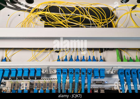 Rack with routers with open top cover and wires inside Stock Photo