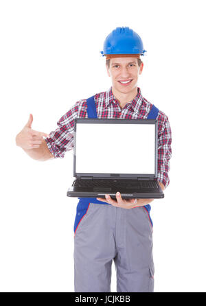 Portrait Of Male Architect Holding Laptop Over White Background Stock Photo