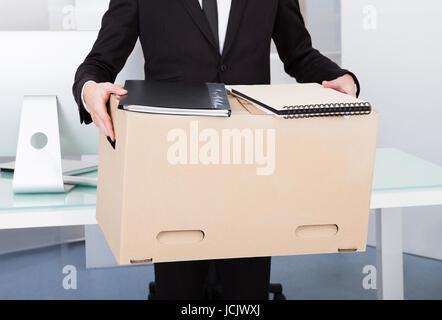 Close-up Of A Businessman Carrying Box At His Workplace Stock Photo