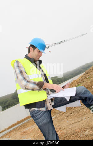 Construction manager using electronic tablet on site Stock Photo