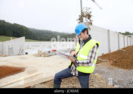 Construction manager using electronic tablet on site Stock Photo