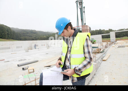 Construction manager using electronic tablet on site Stock Photo