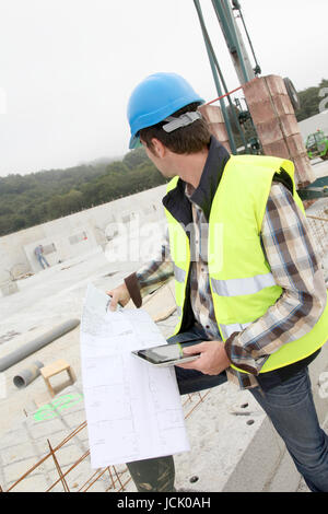 Construction manager using electronic tablet on site Stock Photo