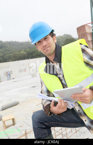 Construction manager using electronic tablet on site Stock Photo