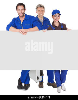 Group of automechanics presenting empty banner. Isolated on white background Stock Photo