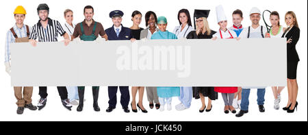 Group of diverse professionals presenting empty banner. Isolated on white Stock Photo