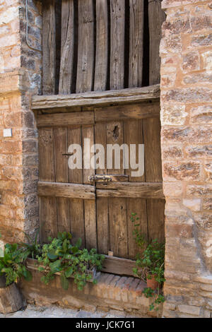 Ancient wooden door in an old Italian town. (Spello, Umbria, Italy) Stock Photo