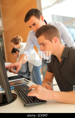 Educator helping student in training class Stock Photo