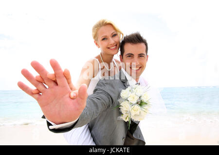 Groom giving piggyback ride to his bride Stock Photo
