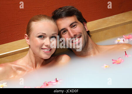 Couple relaxing in spa milk bath Stock Photo