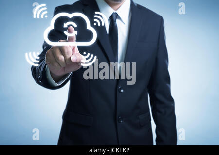 Businessman touch the cloud to sync the data thru wireless internet technologist . Stock Photo
