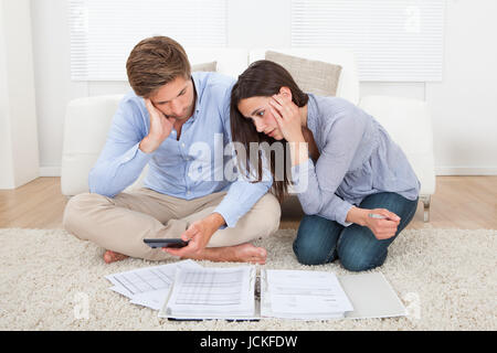 Unhappy young couple in financial trouble at home Stock Photo