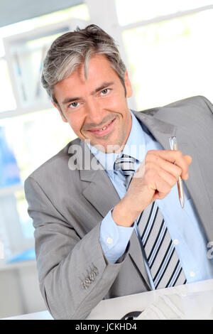 Businessman giving product advantages to client Stock Photo