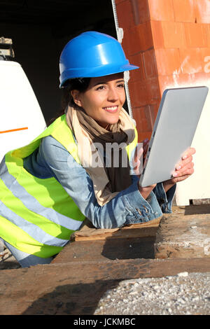 Architect on building site using electronic tablet Stock Photo