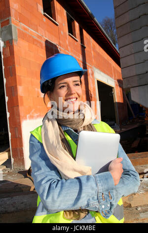Architect on building site using electronic tablet Stock Photo