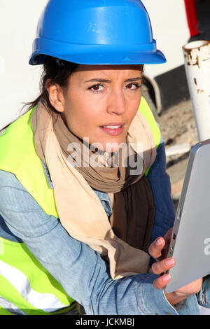 Architect on building site using electronic tablet Stock Photo