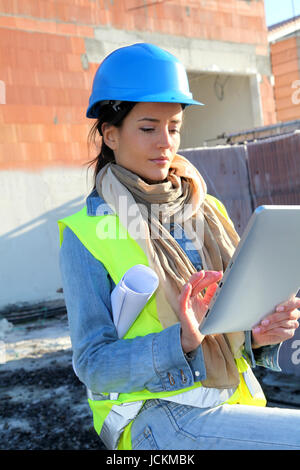 Architect on building site using electronic tablet Stock Photo