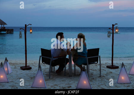 Couple Enjoying Late Meal In Outdoor Restaurant Stock Photo