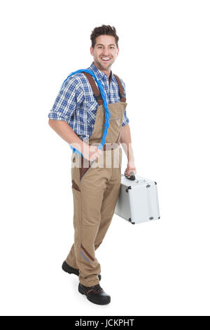 Full length portrait of young male electrician with rolled wire and toolbox over white background Stock Photo