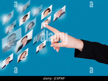 Cropped image of businesswoman selecting candidate on digital interface over blue background Stock Photo