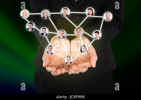 Digital composite image of businesswoman holding connected team representing leadership Stock Photo