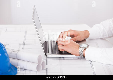 Cropped image of male architect using laptop in office Stock Photo