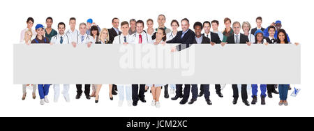 Confident people with various occupations holding blank banner over white background Stock Photo